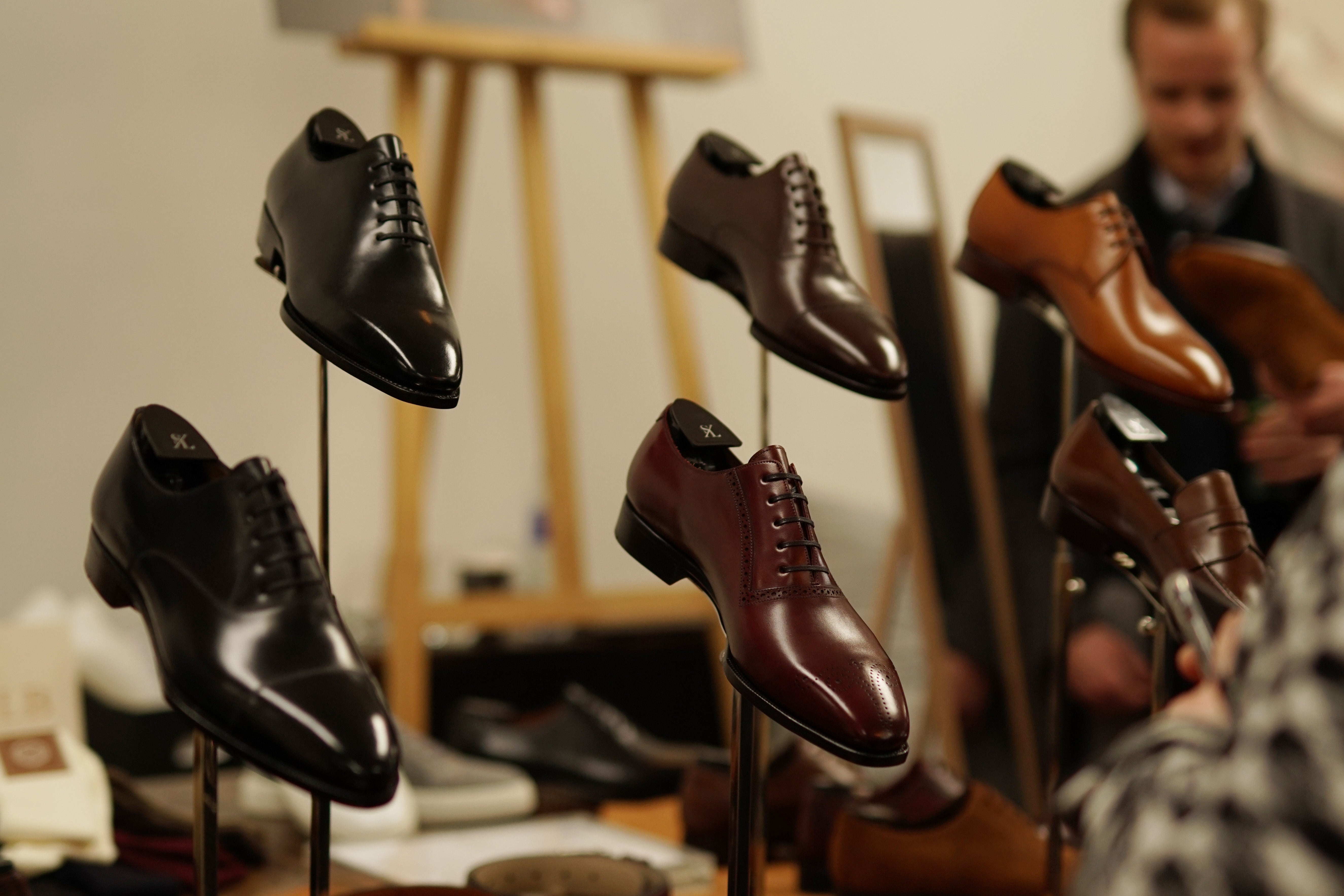 A curated display of fine leather shoes at the Amsterdam Super Trunk Show, capturing the elegance and craftsmanship on exhibit.